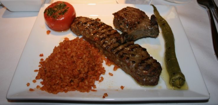 a plate of food with meat and rice