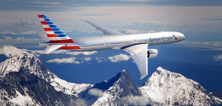 an airplane flying in the sky over mountains