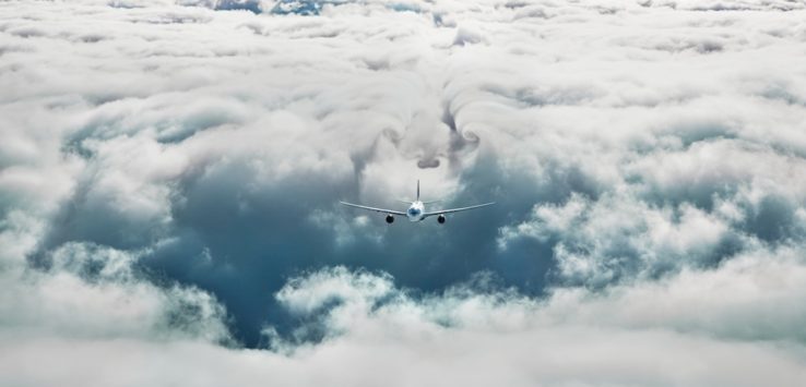 an airplane flying above clouds