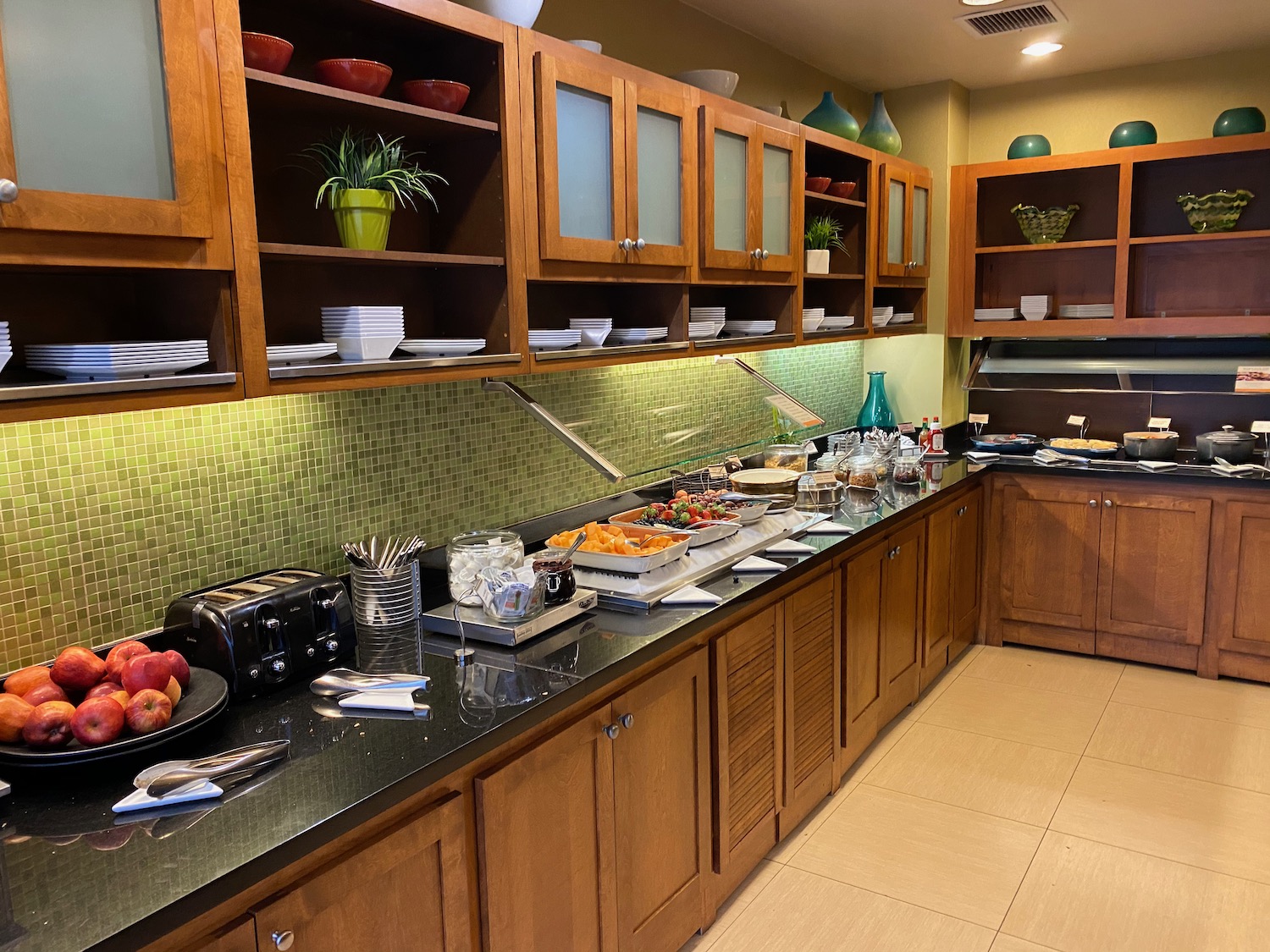 a kitchen with wood cabinets and food on the counter