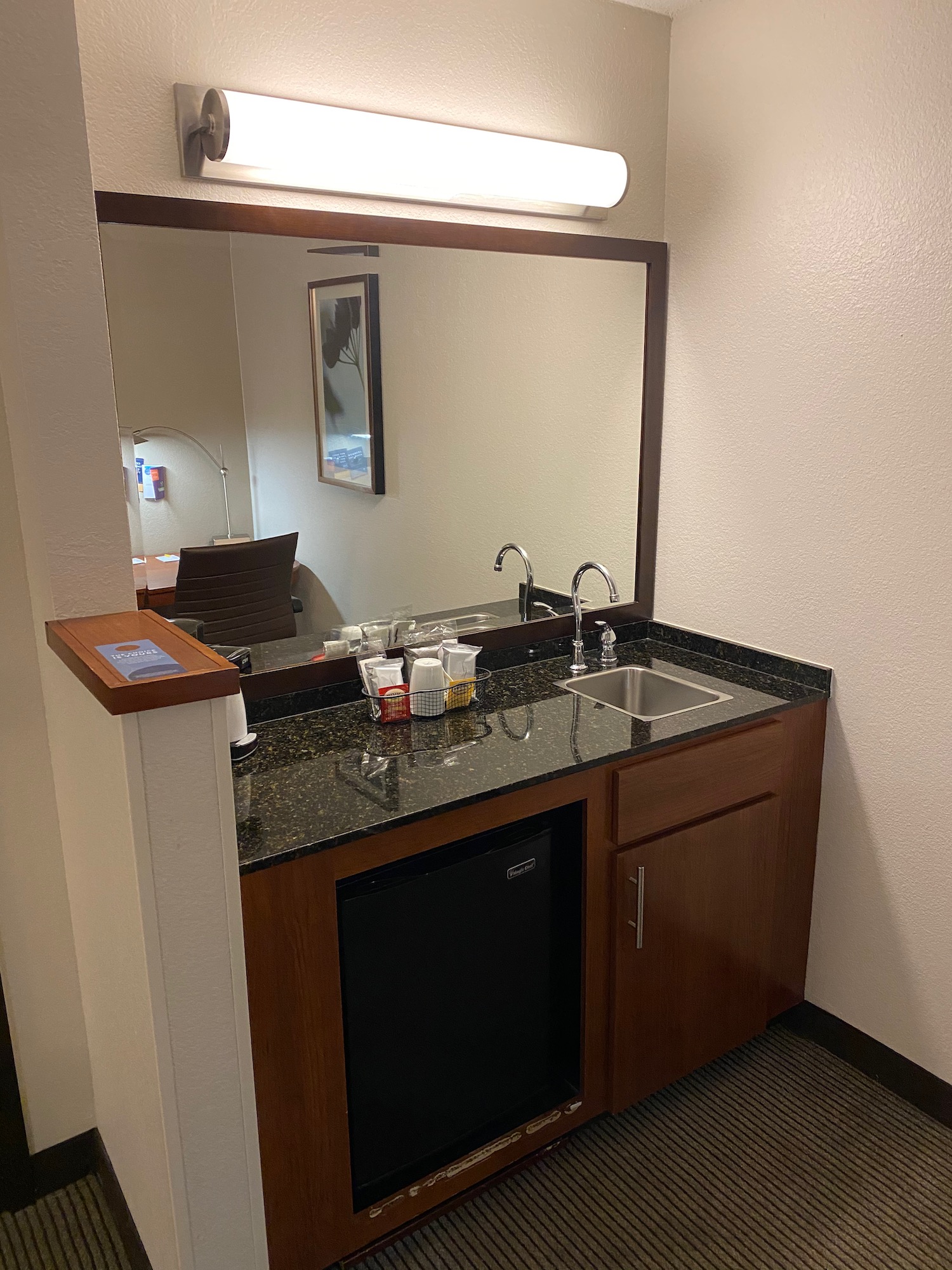 a sink and mirror in a hotel room