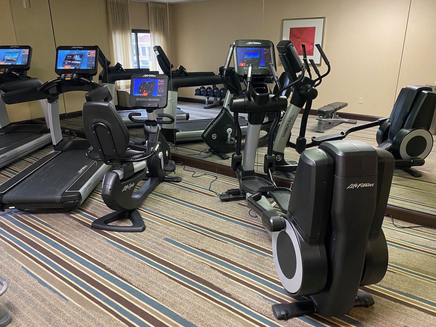 a group of exercise machines in a room