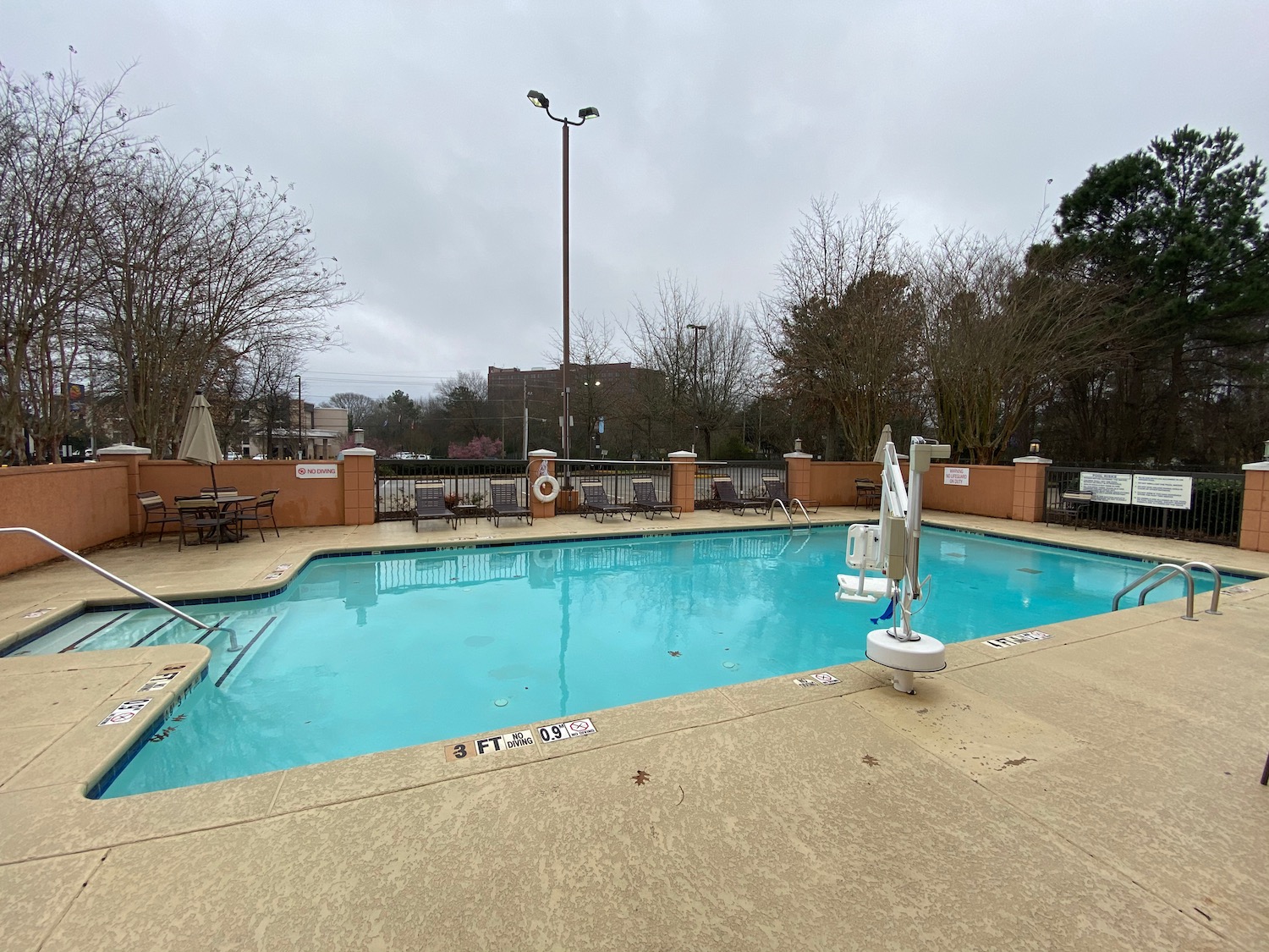 a pool with chairs and a pole