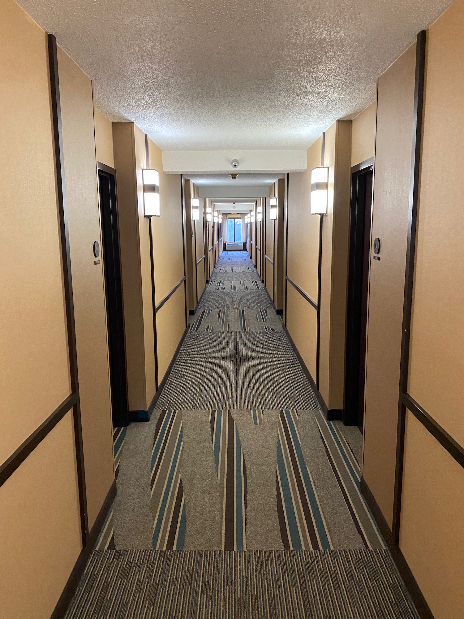 a hallway with lights on the walls