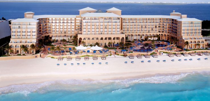 a large building with many windows and a beach