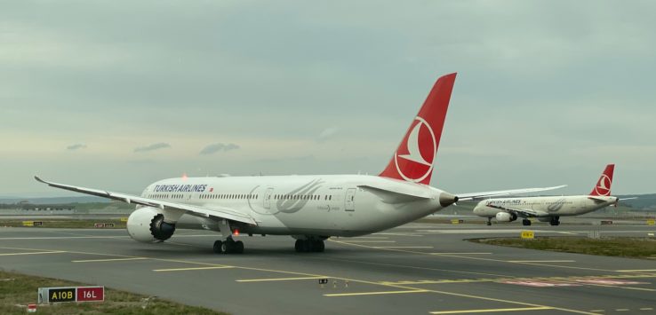 a group of airplanes on a runway