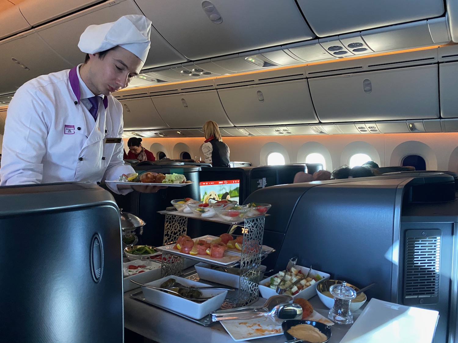 a chef serving food on an airplane