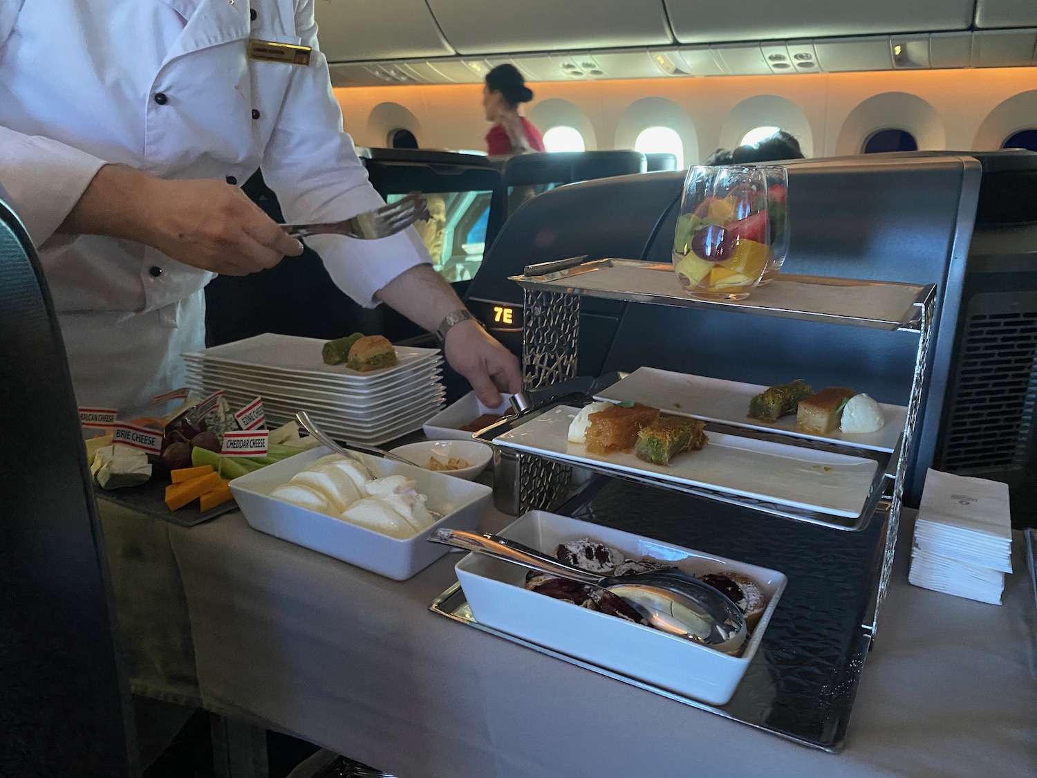 a person in a white uniform serving food on a table