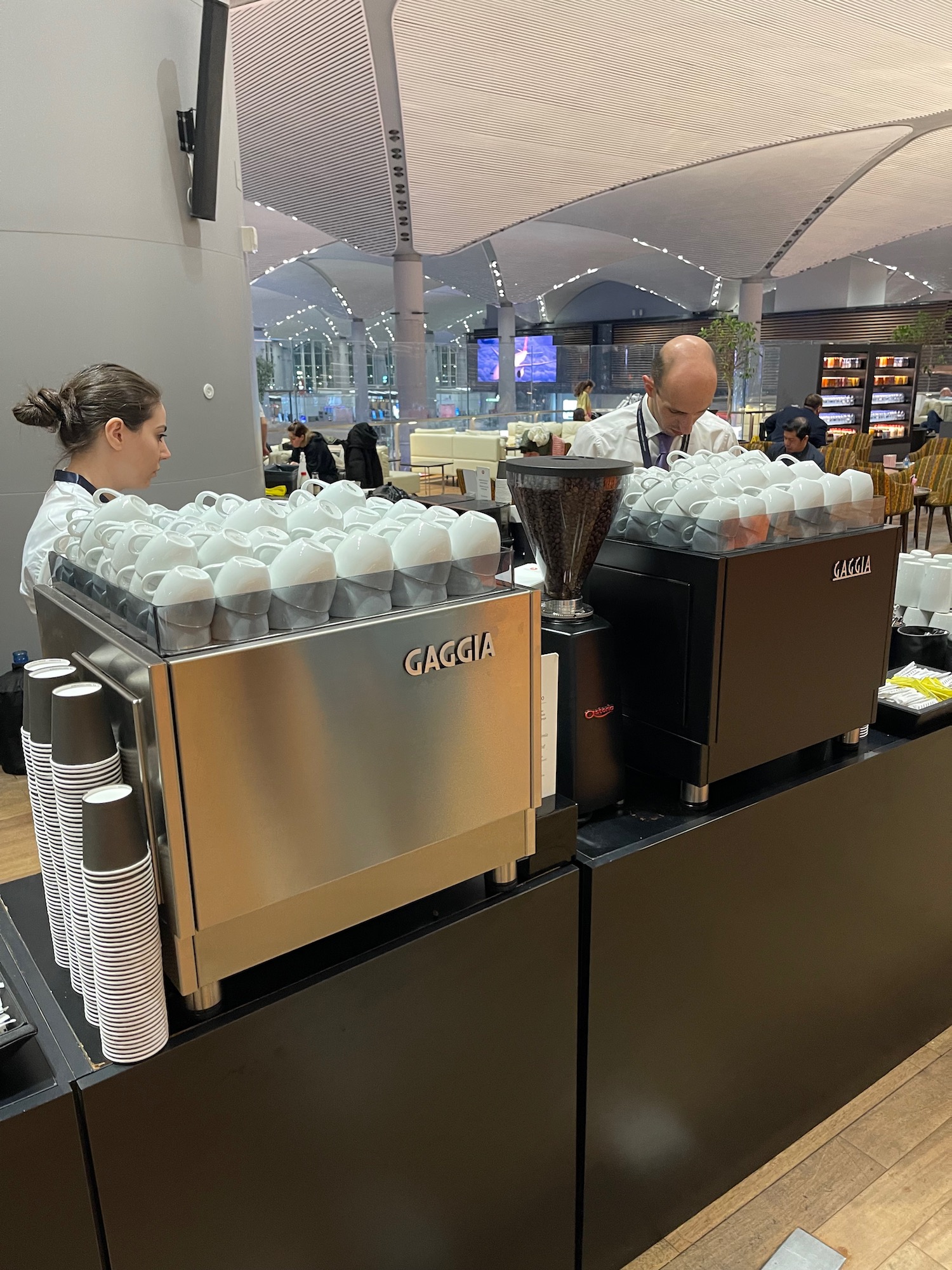 a man and woman working at a coffee machine