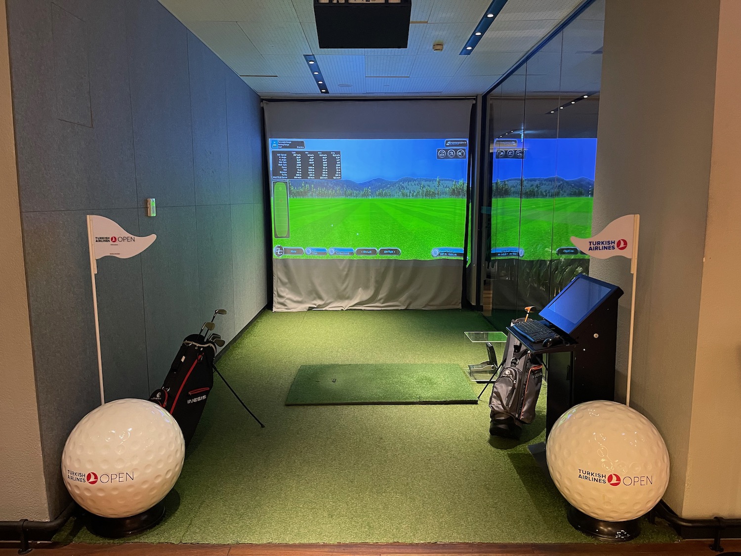 a golf club with golf clubs and a screen