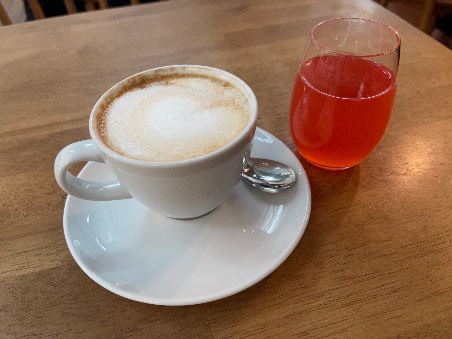 a cup of coffee and a glass of liquid on a table