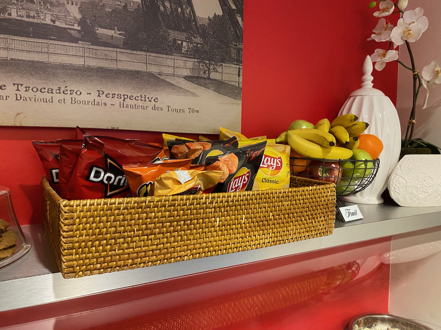 a basket of chips and fruit on a shelf