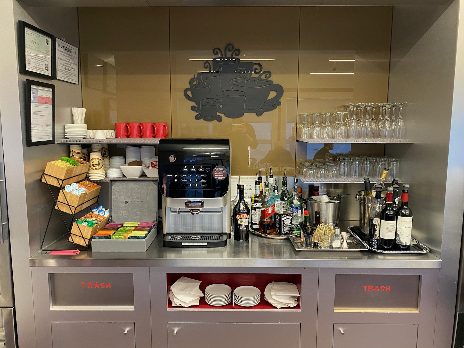 a coffee machine and wine glasses on a counter