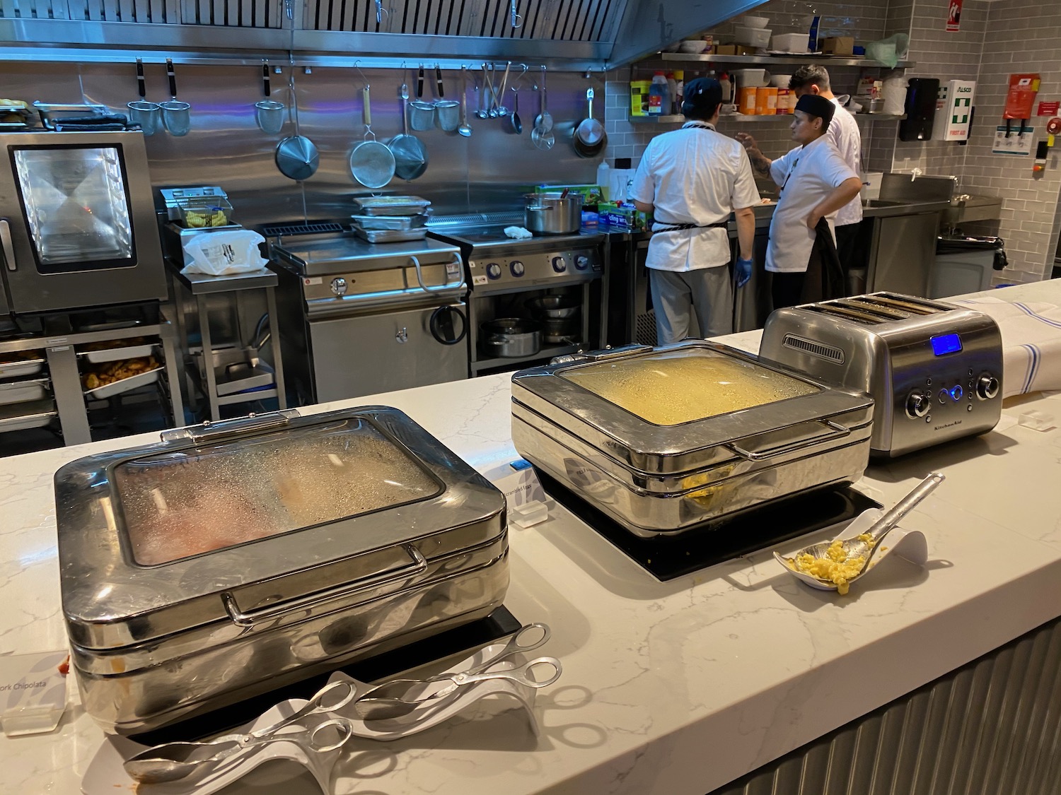 a kitchen with many stainless steel containers