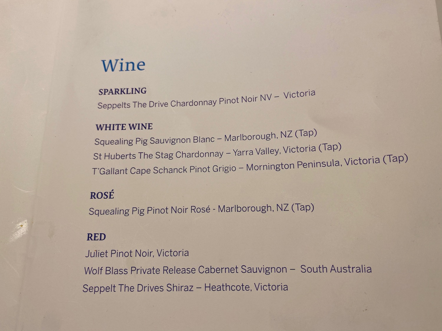 a menu of wine with blue text