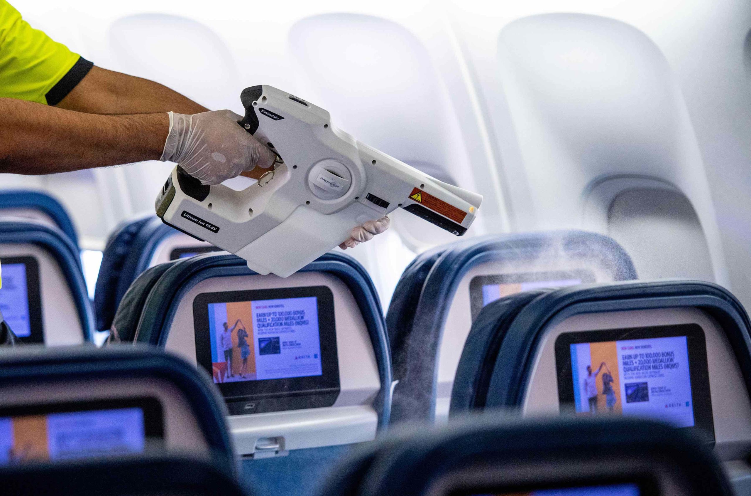 a person holding a gun in an airplane