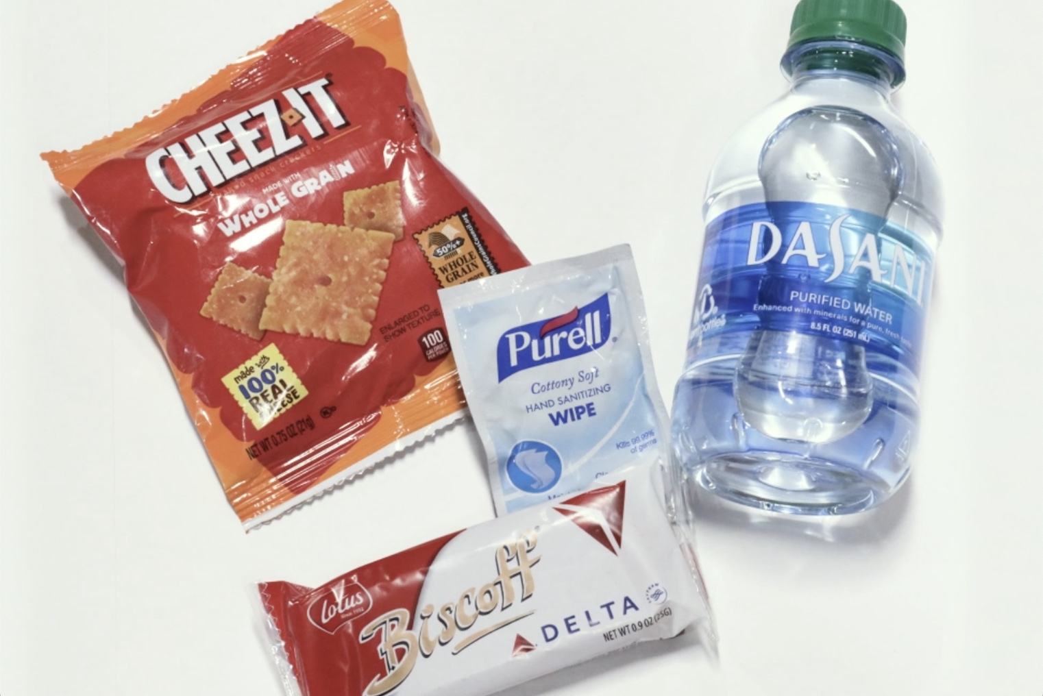 a bottle of water and crackers and a bag of chips