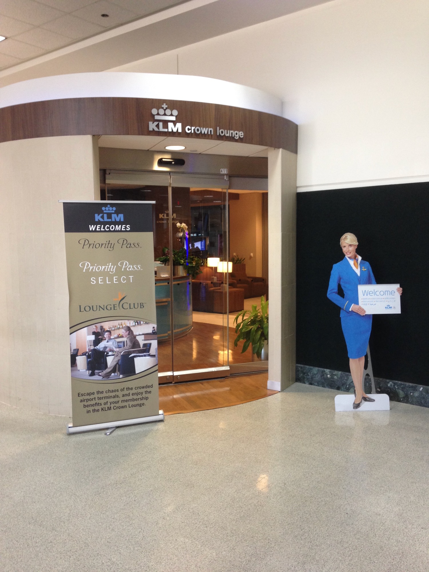 a statue of a woman holding a sign in front of a glass door