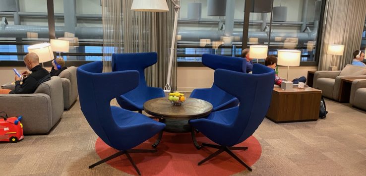 a group of blue chairs around a round table