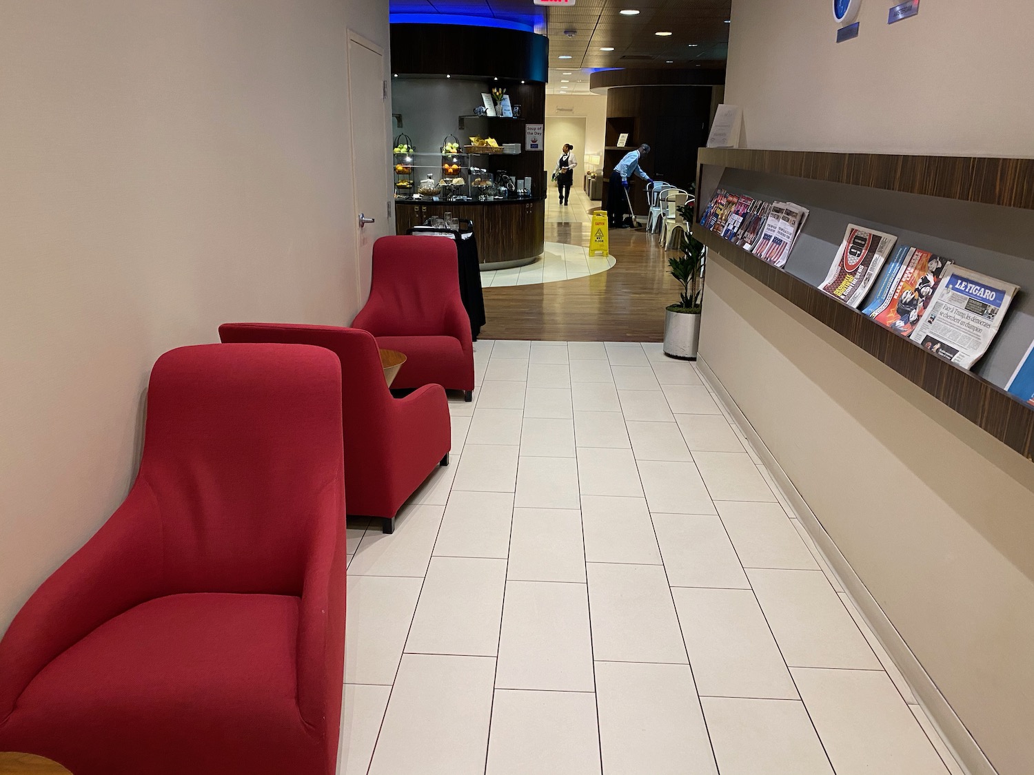 a room with red chairs and a shelf