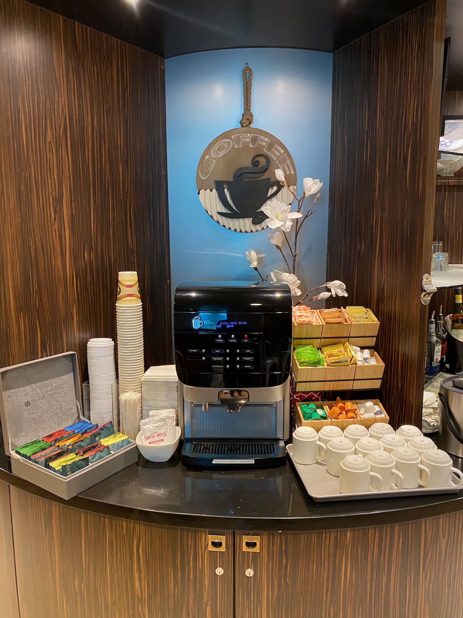 a coffee machine and cups on a counter