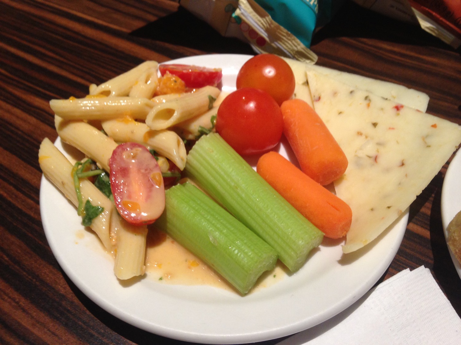 a plate of food with pasta carrots and cheese