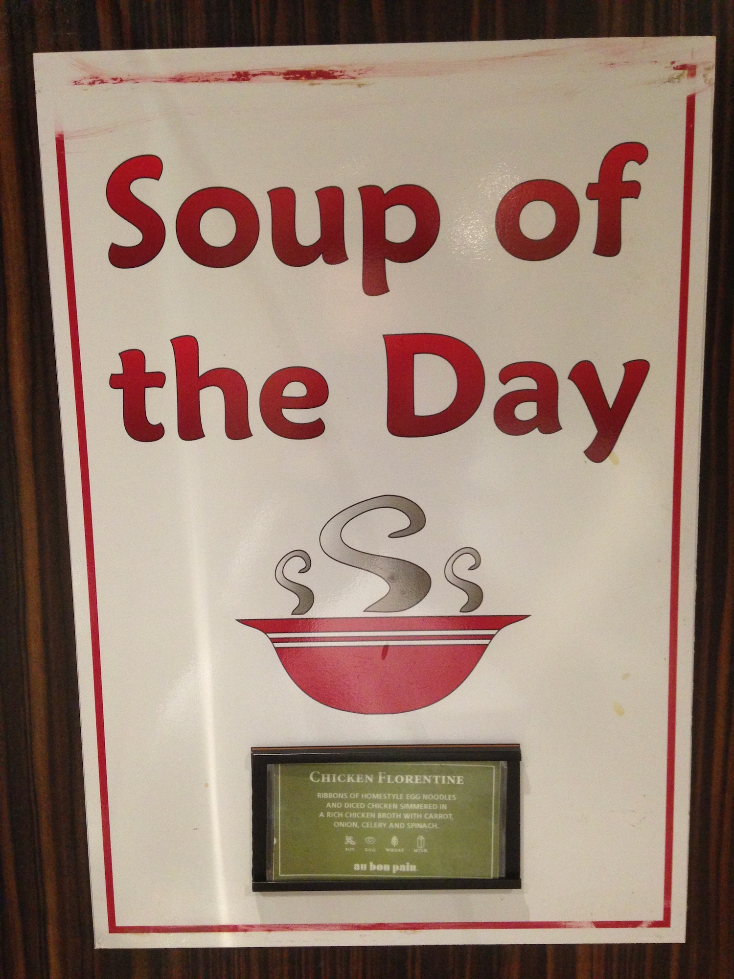 a sign with a picture frame and a bowl of soup
