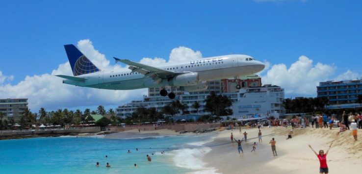 a plane flying over a beach