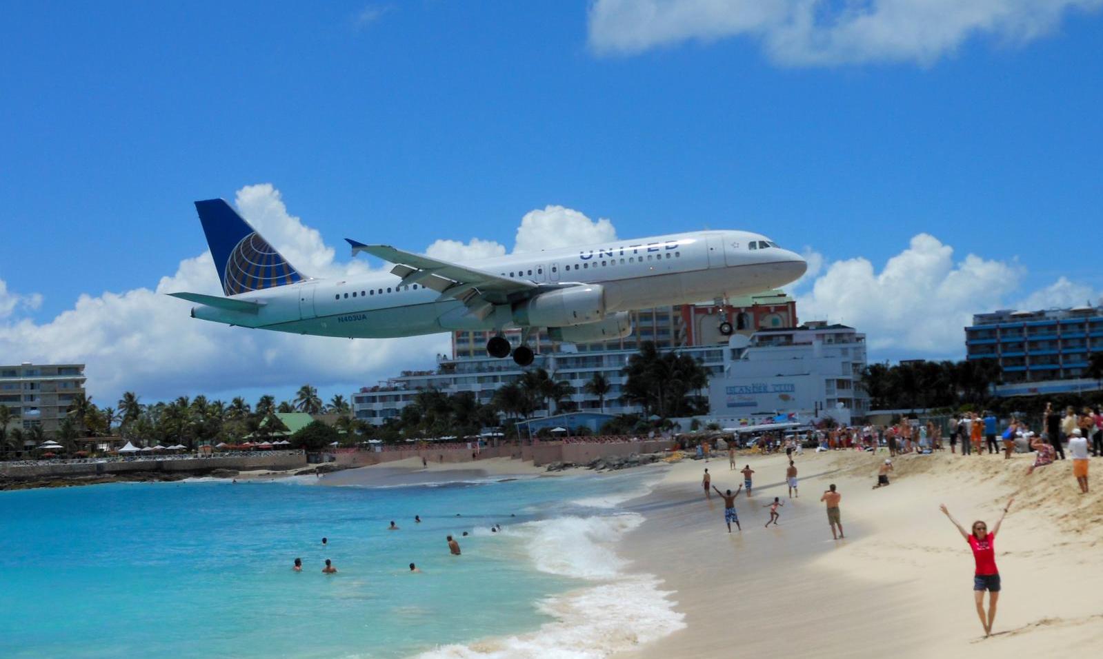 a plane flying over a beach