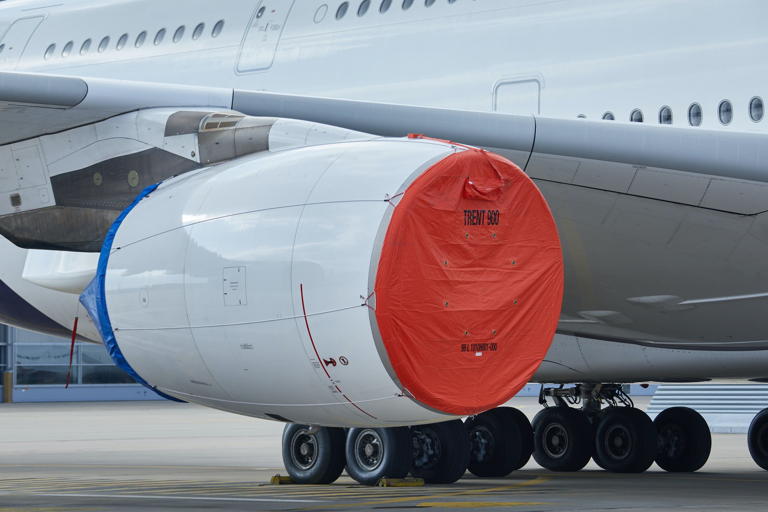 a large white airplane with red cover