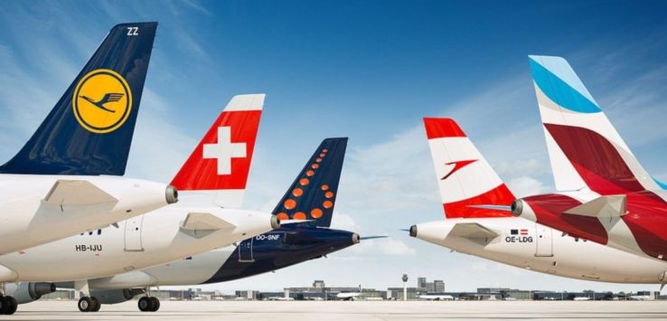 a group of airplanes parked on a runway