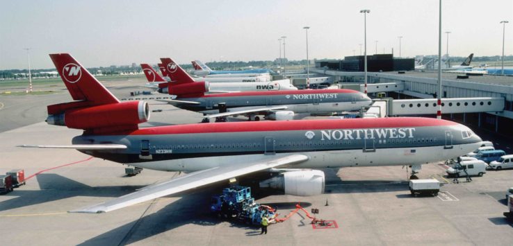 a group of airplanes at an airport