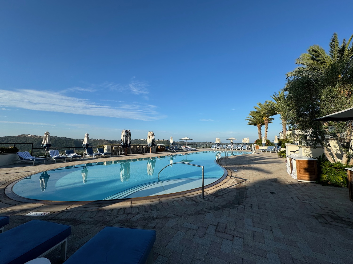 a pool with chairs and umbrellas