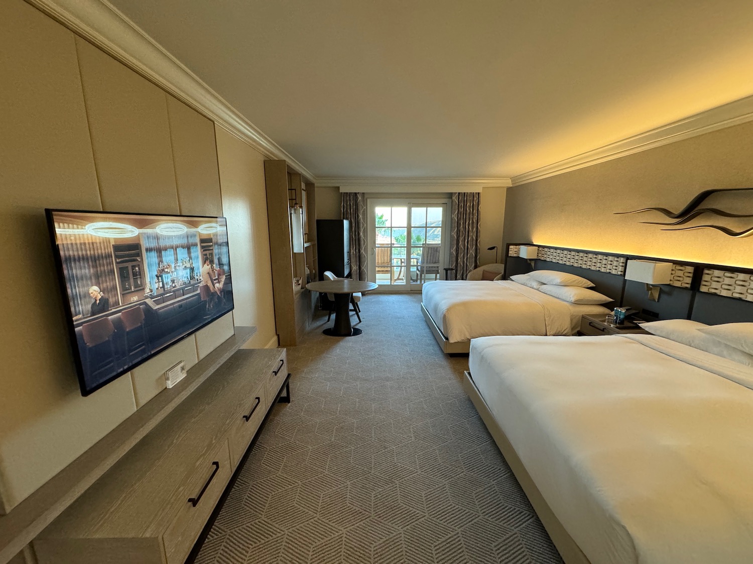 a room with two beds and a television