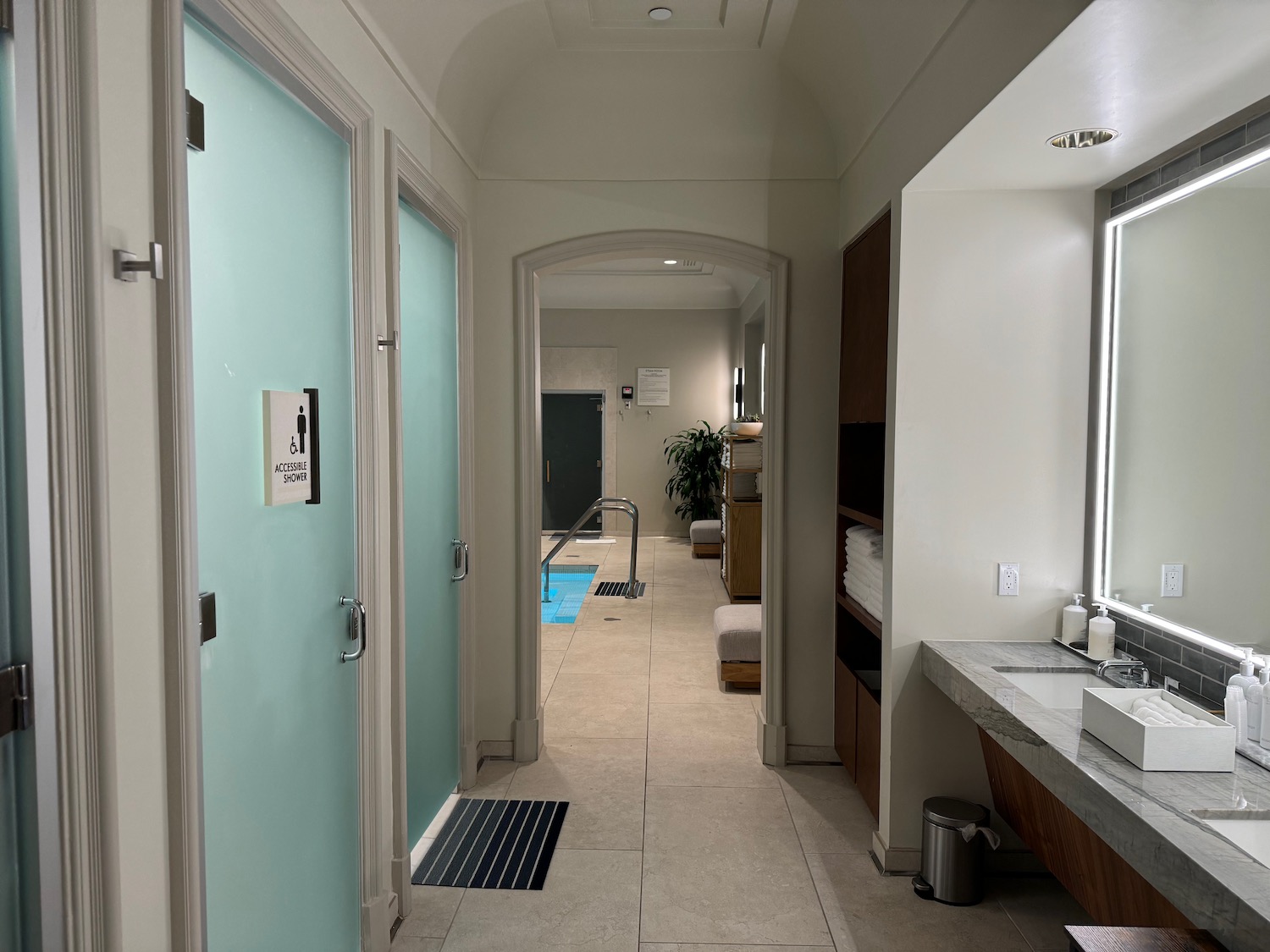 a hallway with a blue door and a pool