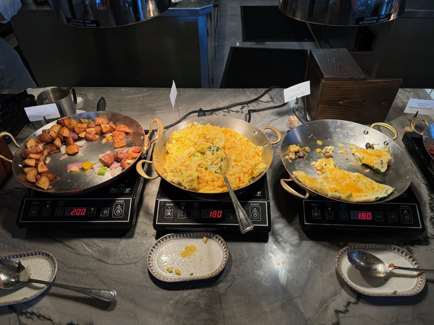 a group of pans with food on a counter