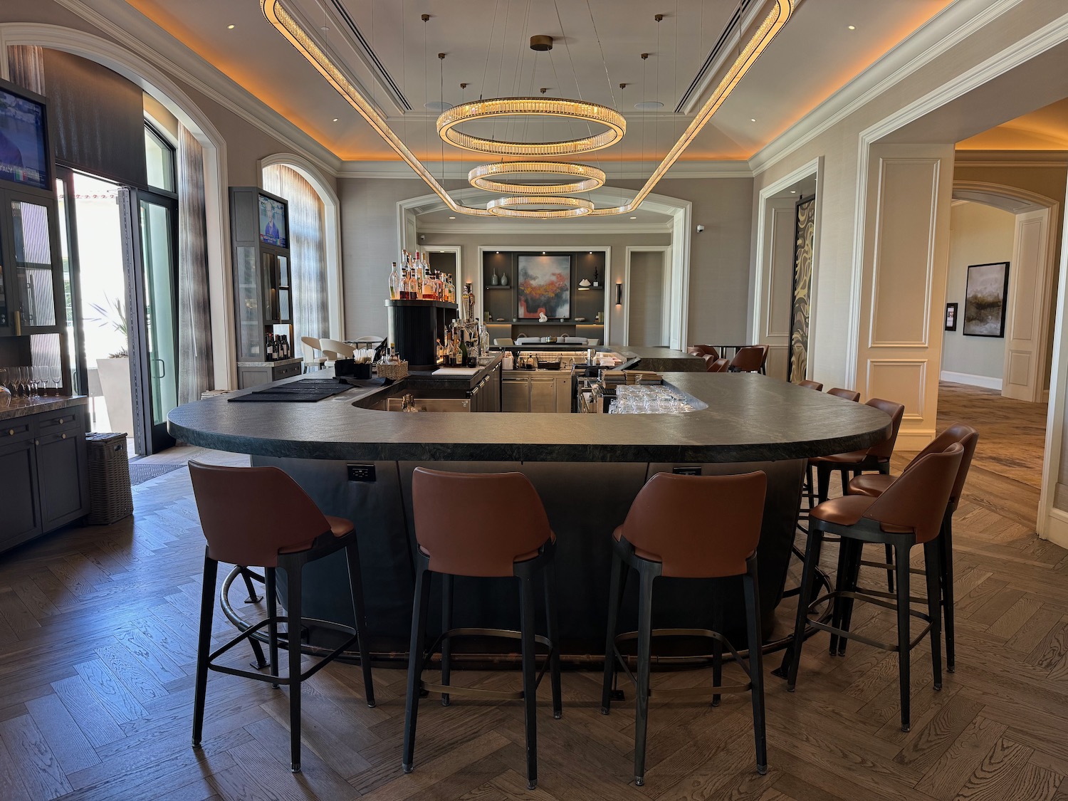 a bar with a counter and chairs in a room