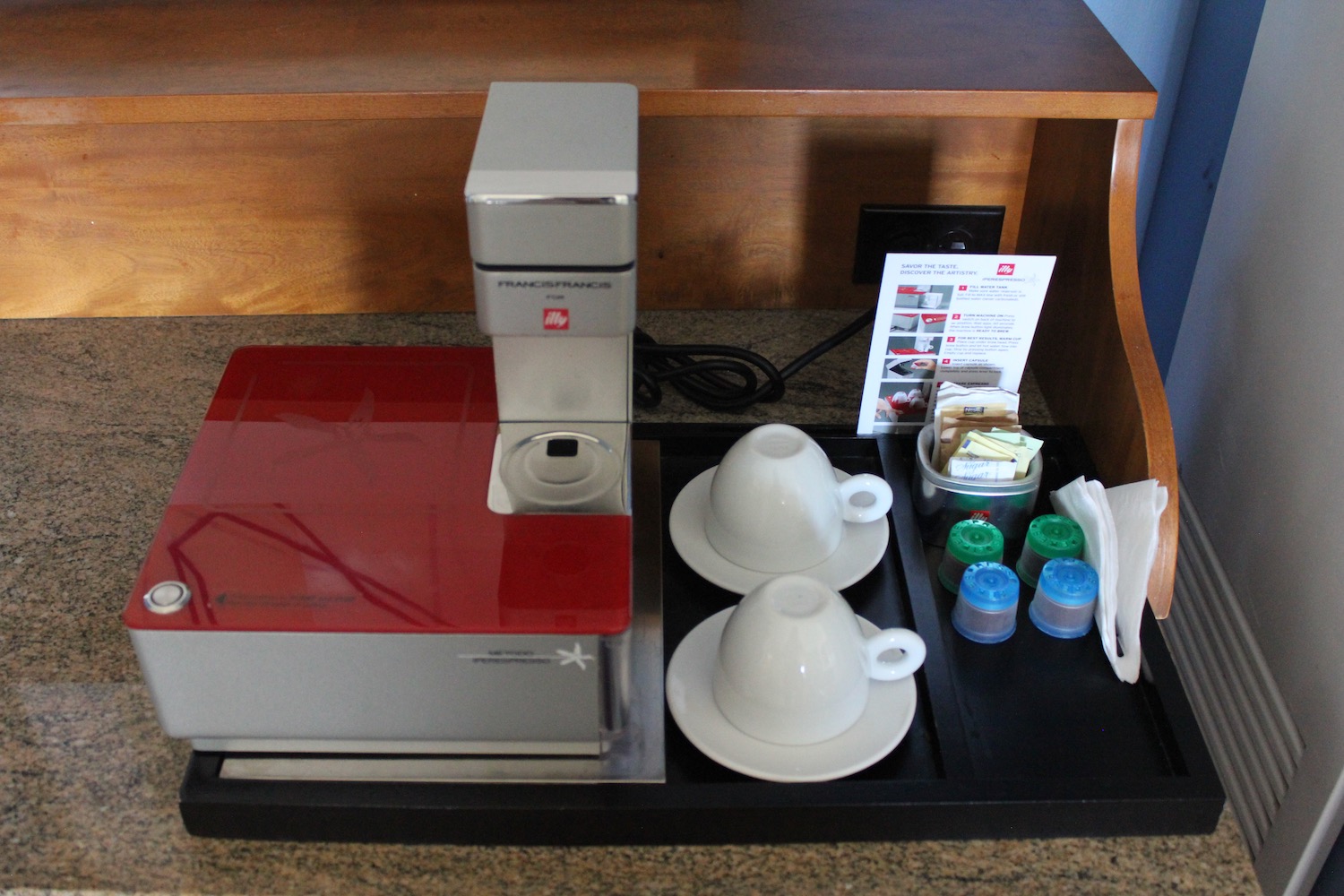 a coffee machine and cups on a tray