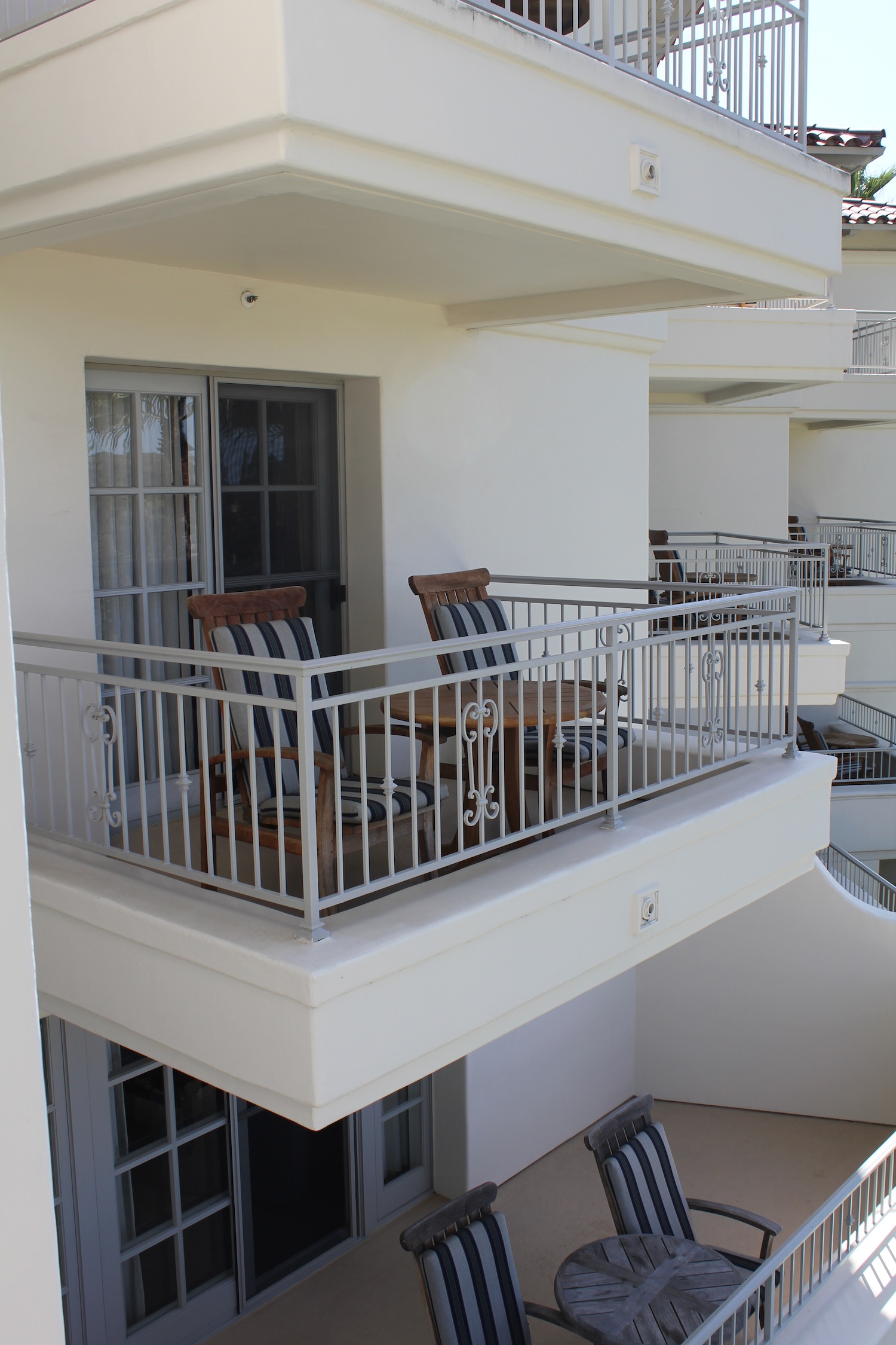 chairs on a balcony with a white railing