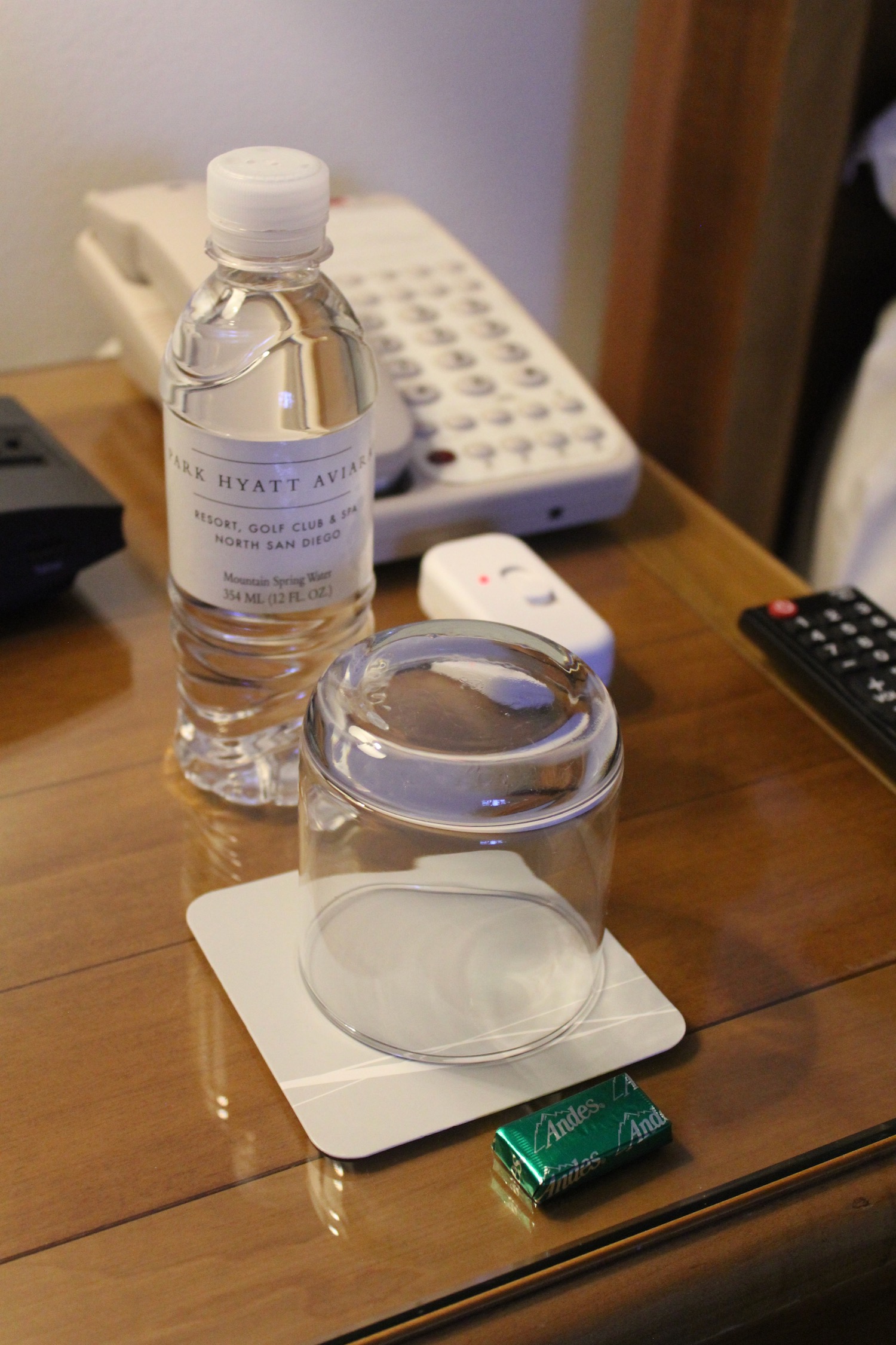 a bottle of water and a glass on a table