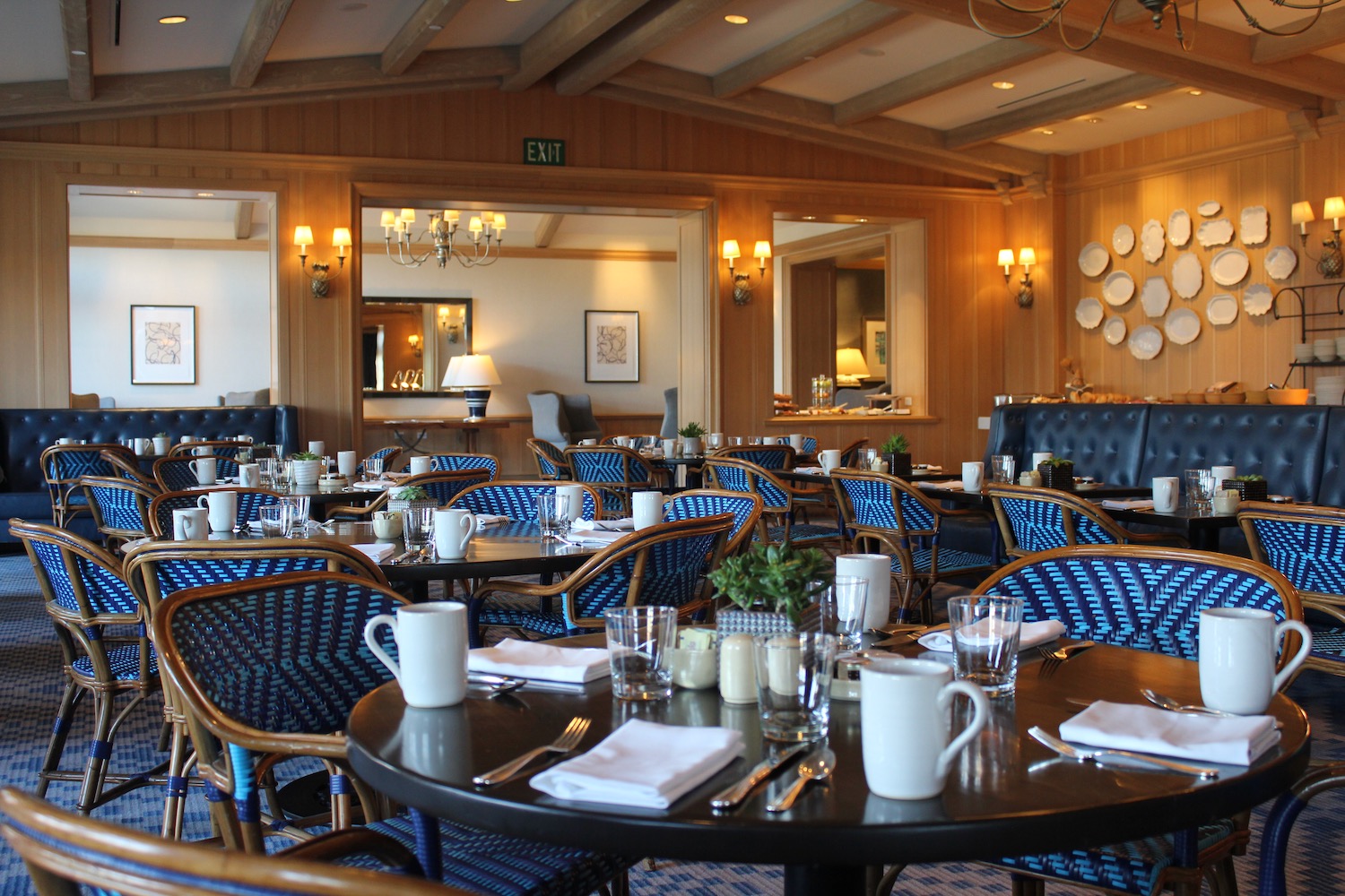 a restaurant with blue chairs and tables