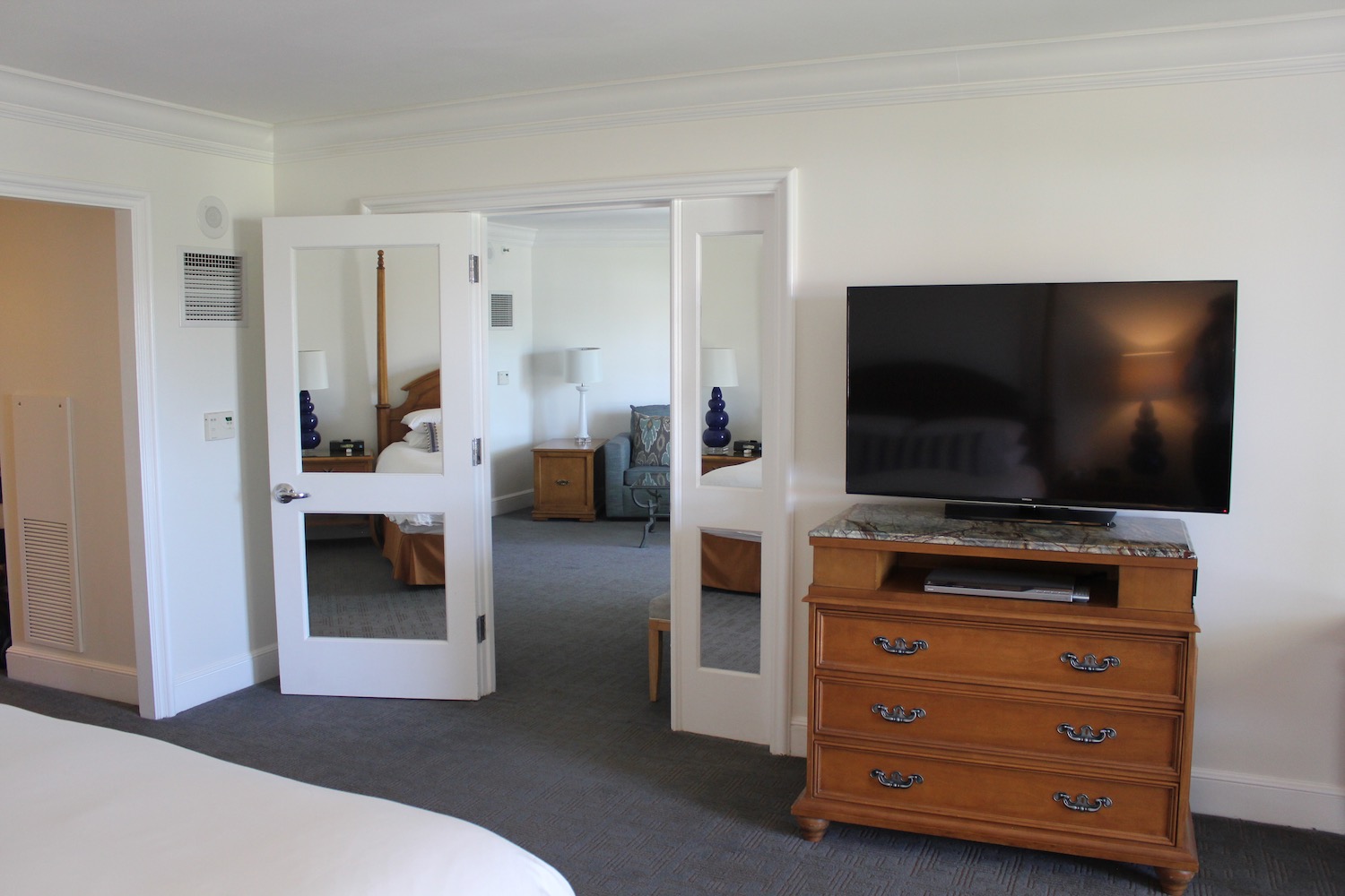 a bedroom with a television and a dresser