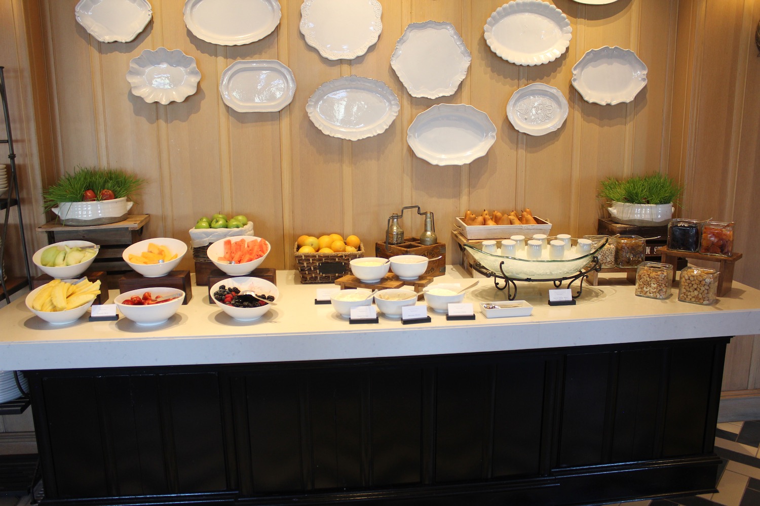 a buffet table with plates on the wall