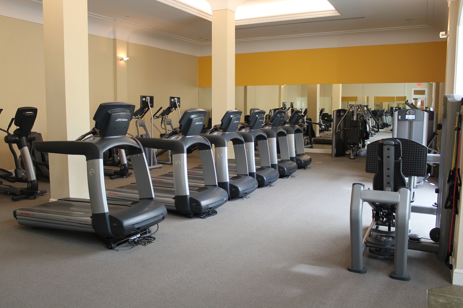 a room with treadmills and exercise equipment