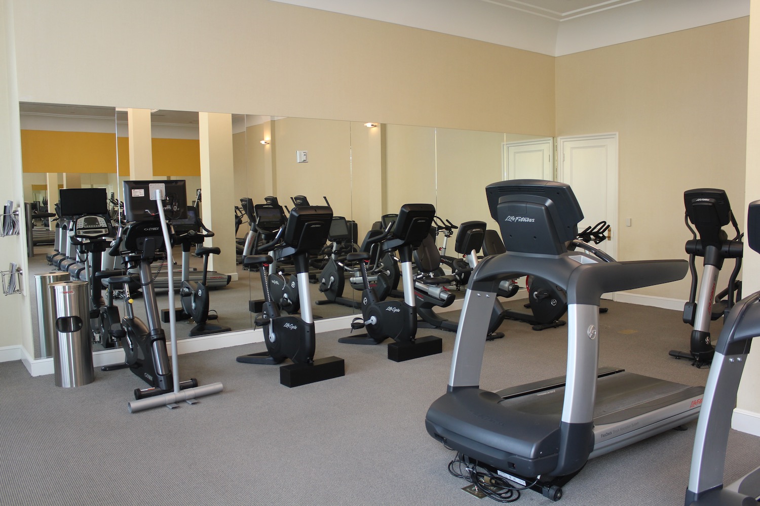 a room with exercise bikes and mirrors