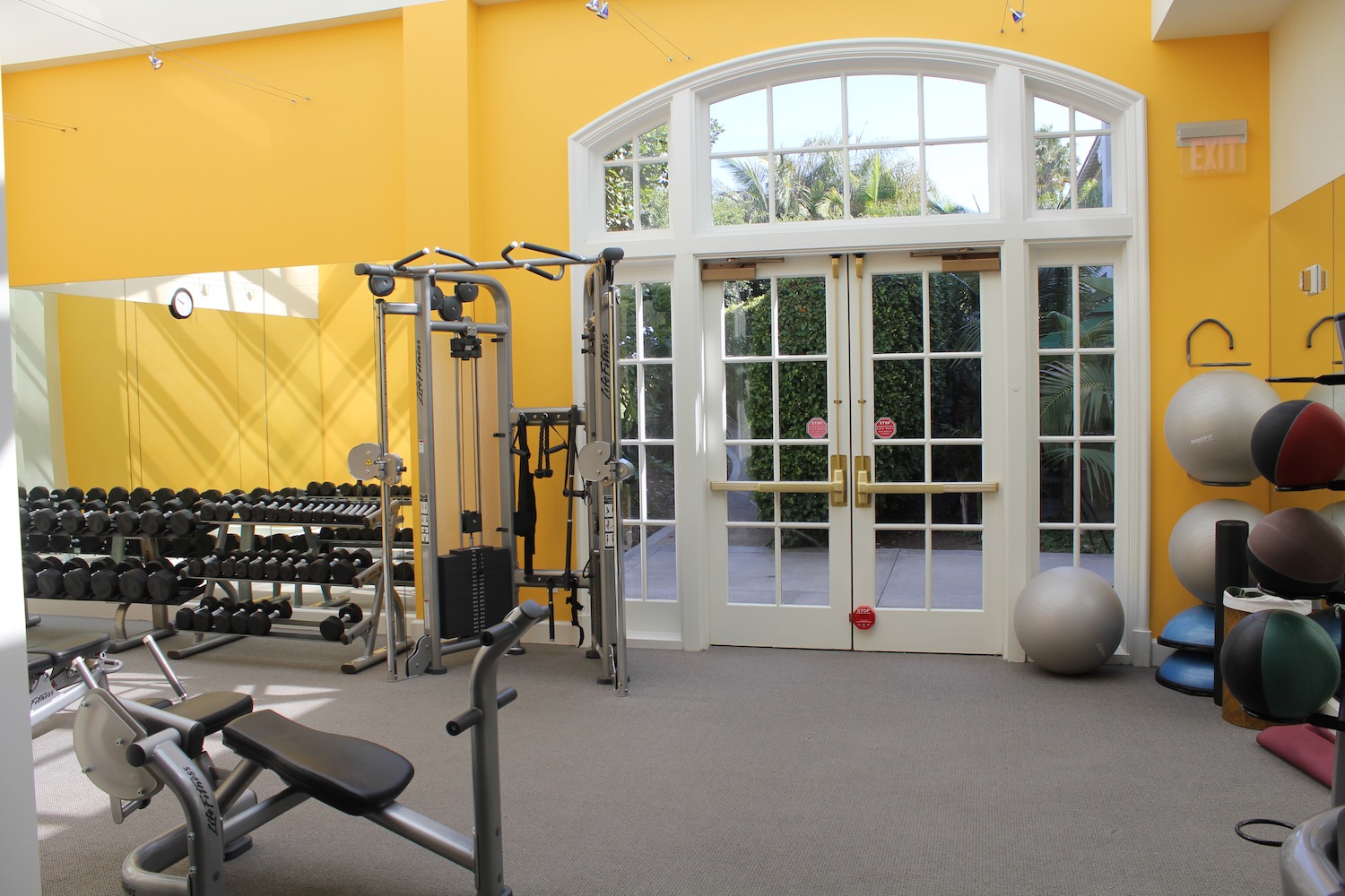 a gym with exercise equipment and a ball