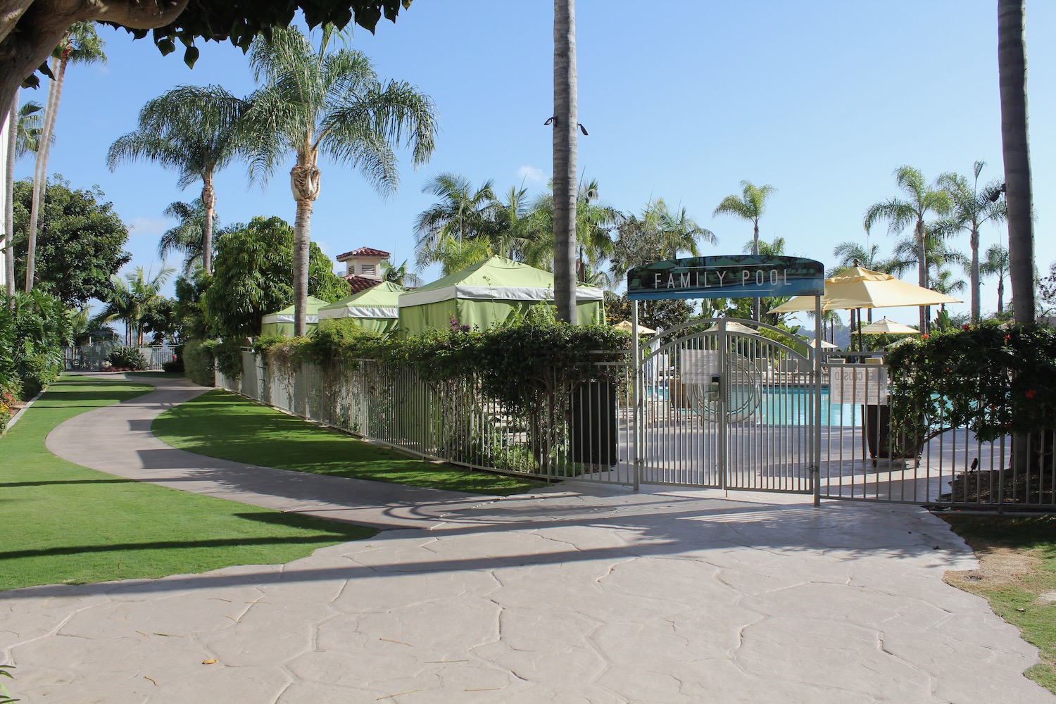 a pool with a gate and trees