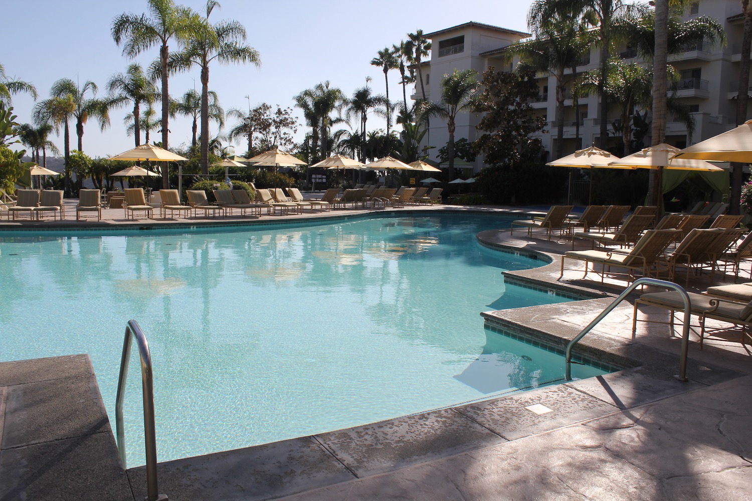 a pool with umbrellas and chairs