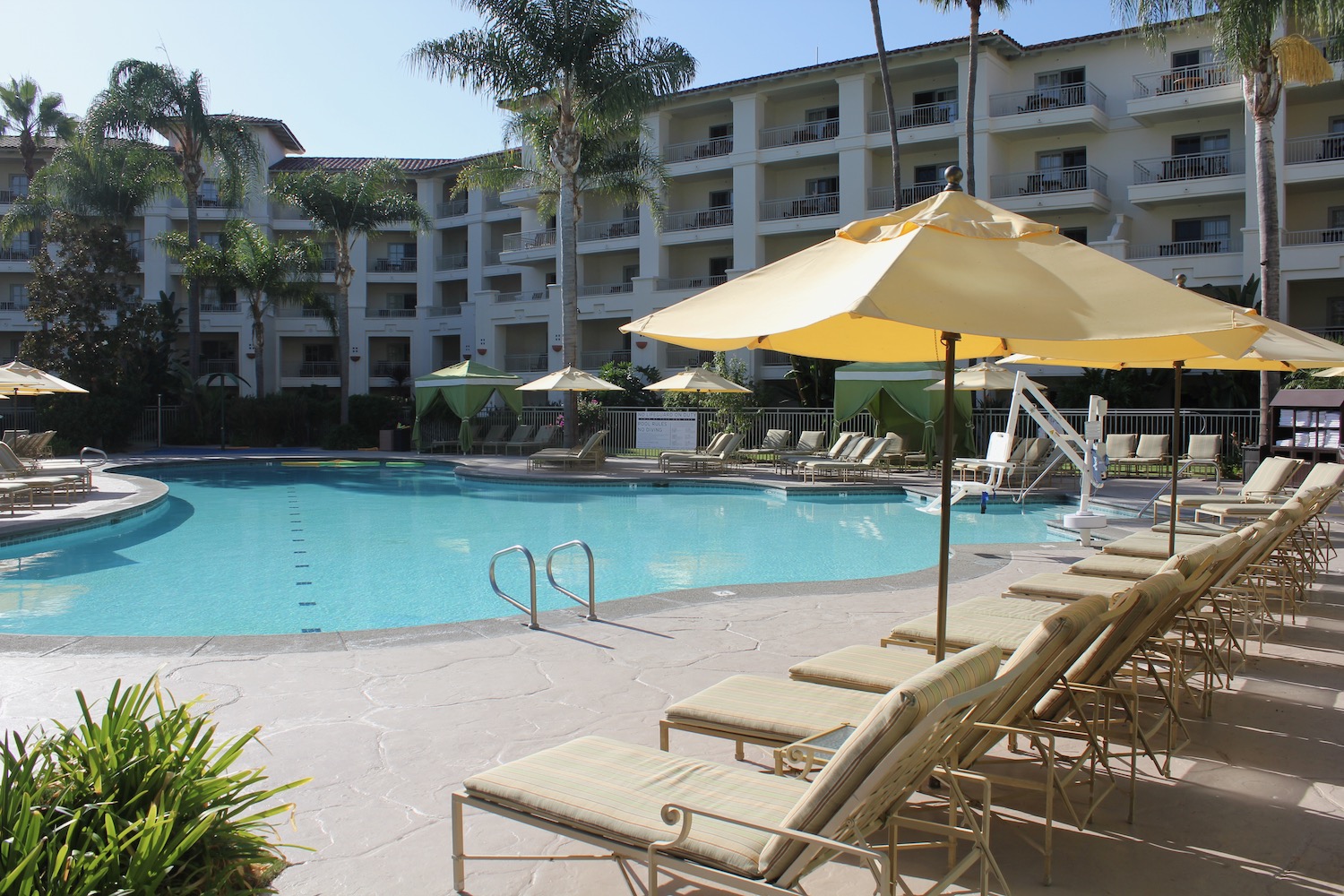 a pool with chairs and umbrellas