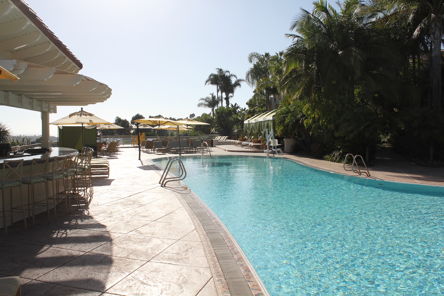 a pool with umbrellas and chairs